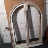 Old arched window made of fir wood