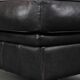 Set of a black cowhide leather Chesterfield armchair and matching ottoman