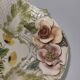 Openwork ceramic bowl with raised flower decoration in Italian style.