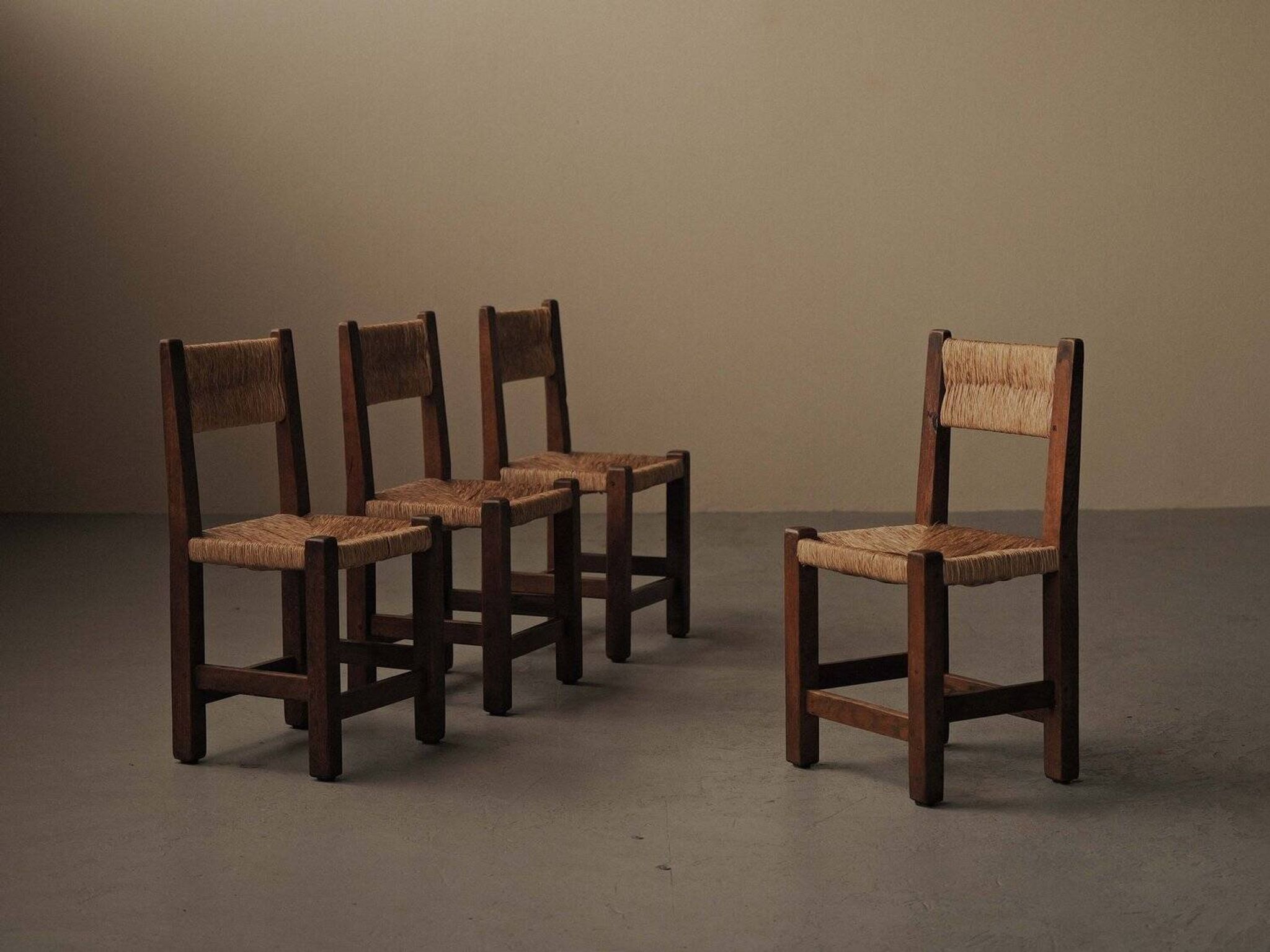 Set of four modernist chairs in oak and straw, France, circa 1960.