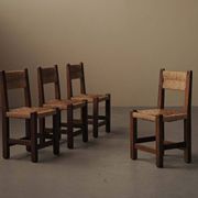 Set of four modernist chairs in oak and straw, France, circa 1960.