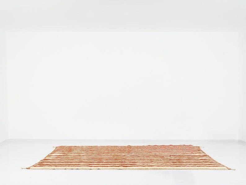 A handmade Moroccan striped terracotta rug, 150/250cm