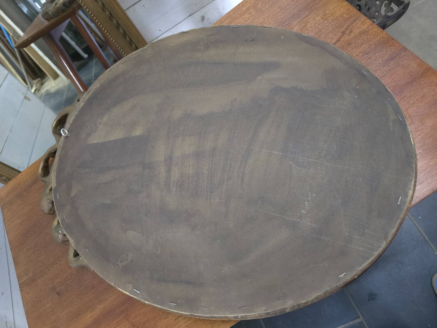 Oval mirror with gold patina