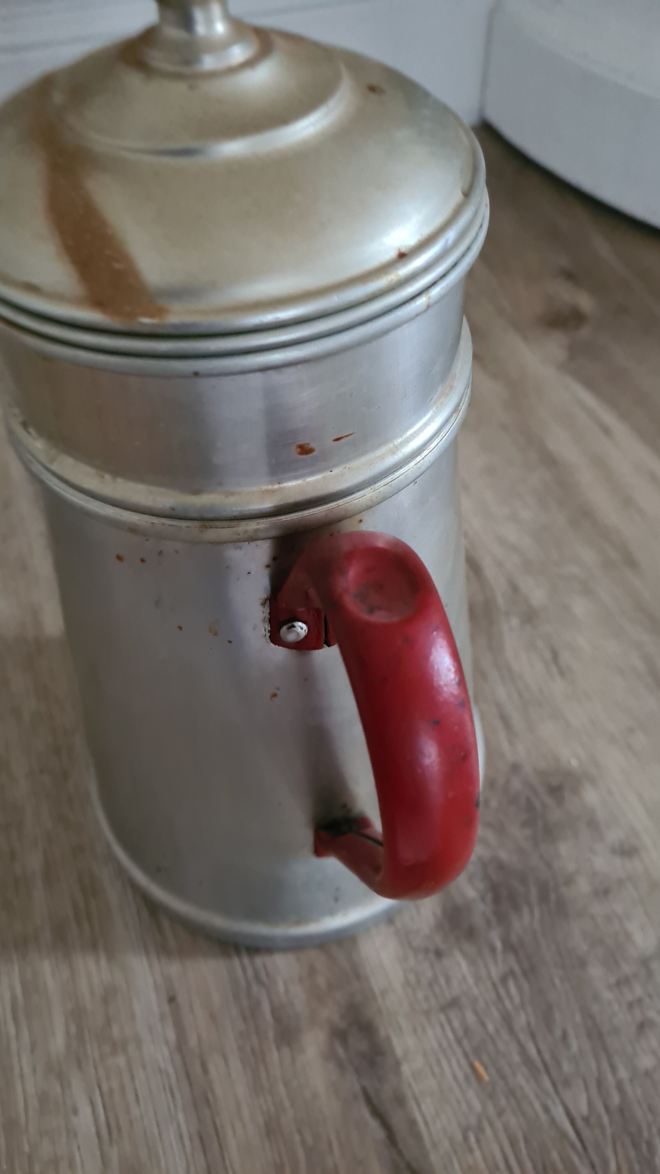 Old enamelled coffee maker in red handle aluminum