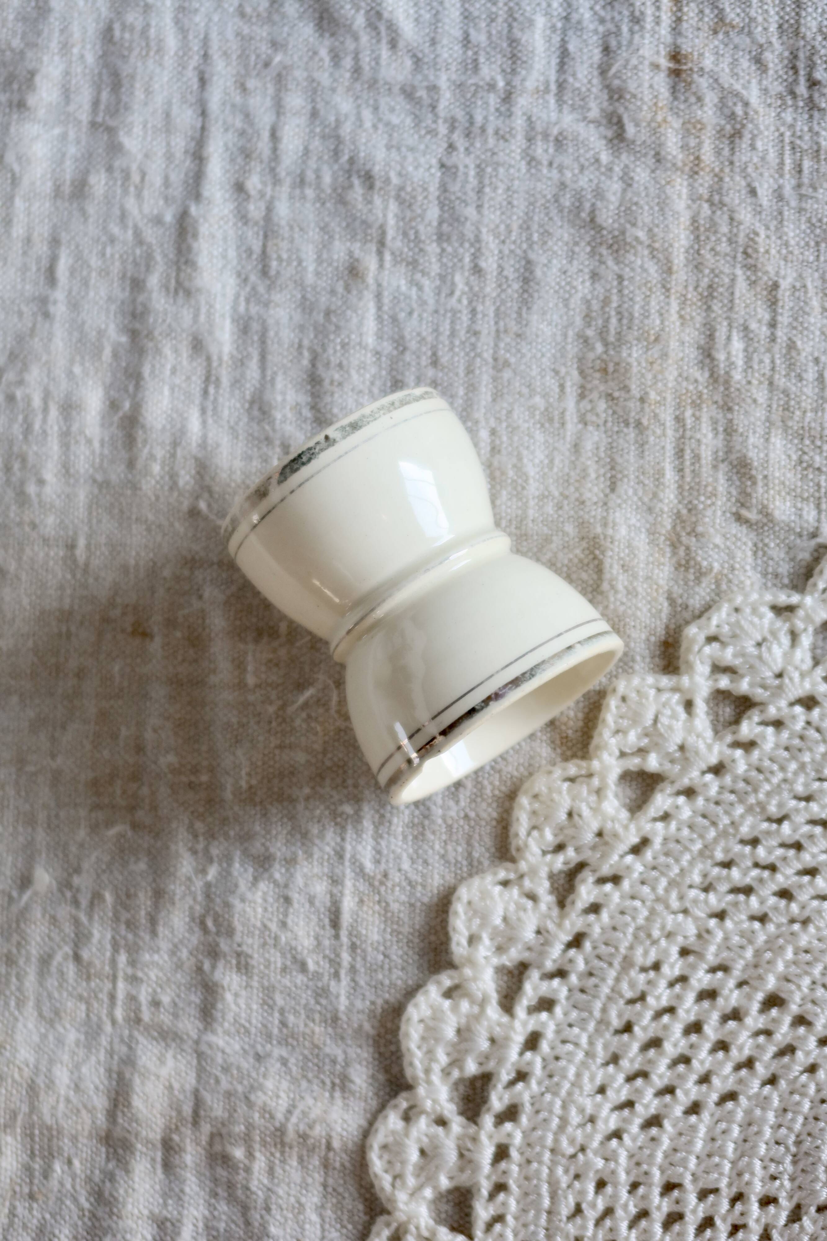 Antique egg cup, ironstone diabolo, ivory and gold edging