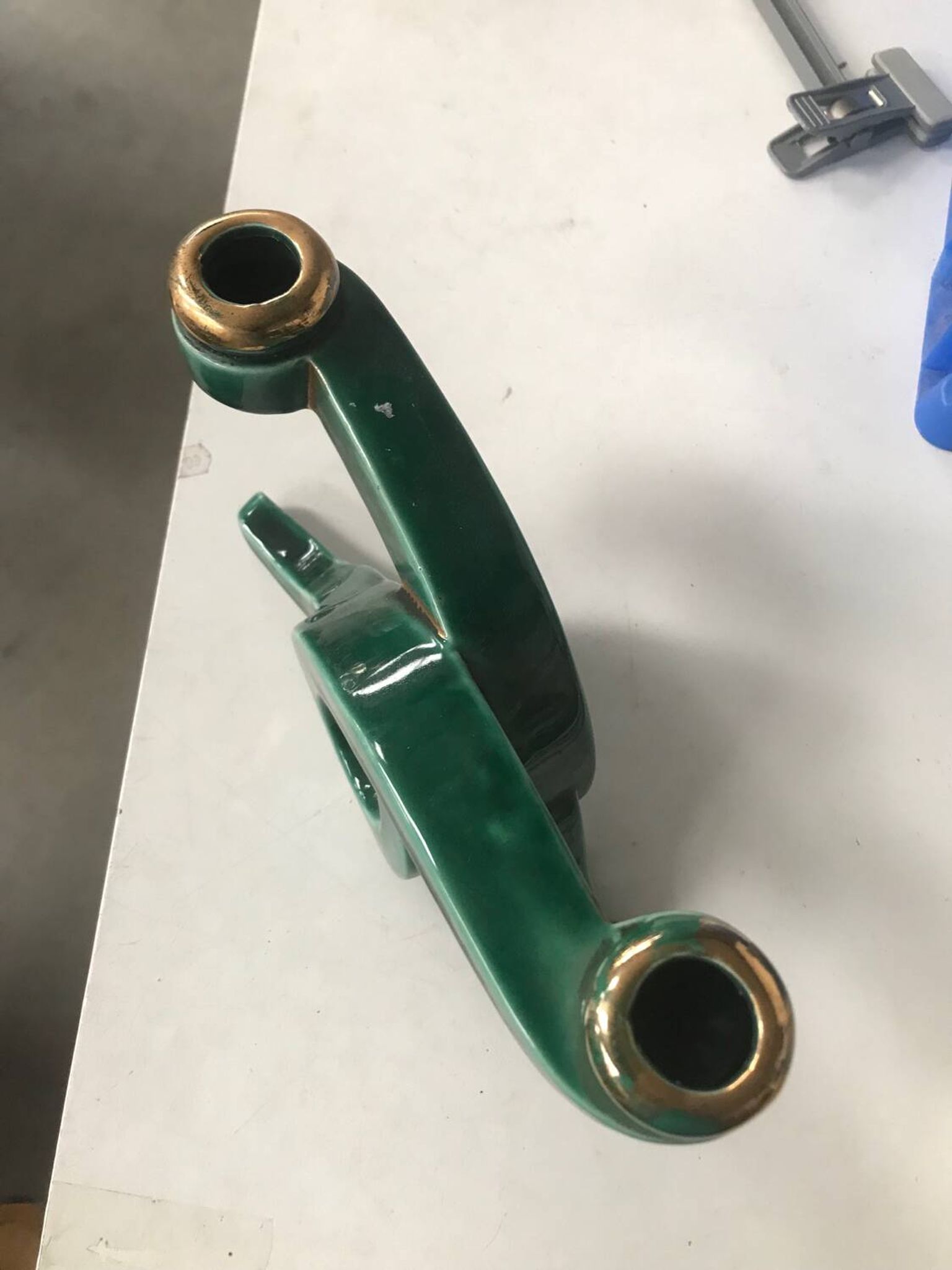 Art Deco candlestick in green and gold earthenware.