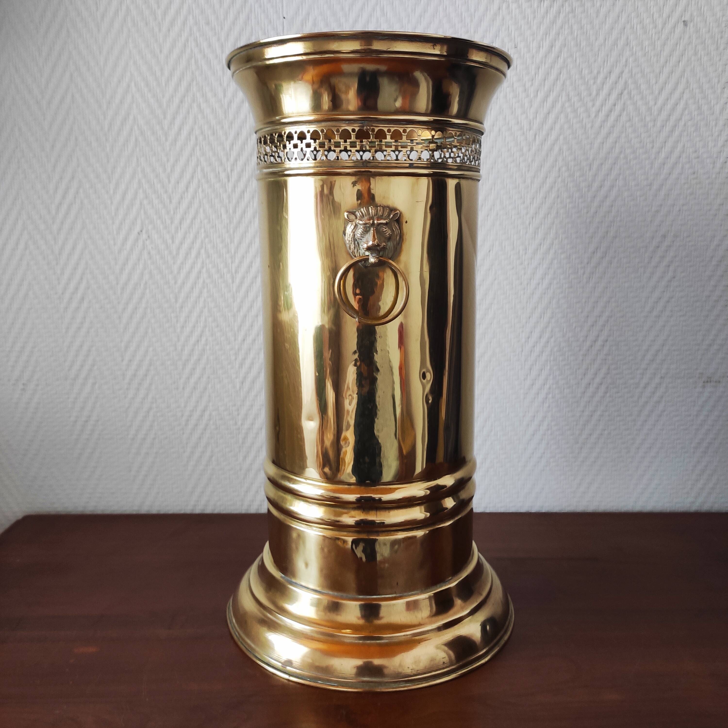 Vintage brass umbrella stand with lion decoration.