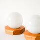 Pair of globe wall lights in opaline with a pine base, 1980.