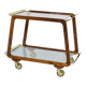 May include: A mid-century modern bar cart with a dark wood frame and two c