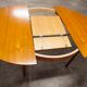Scandinavian table in round teak with built-in extensions 1960