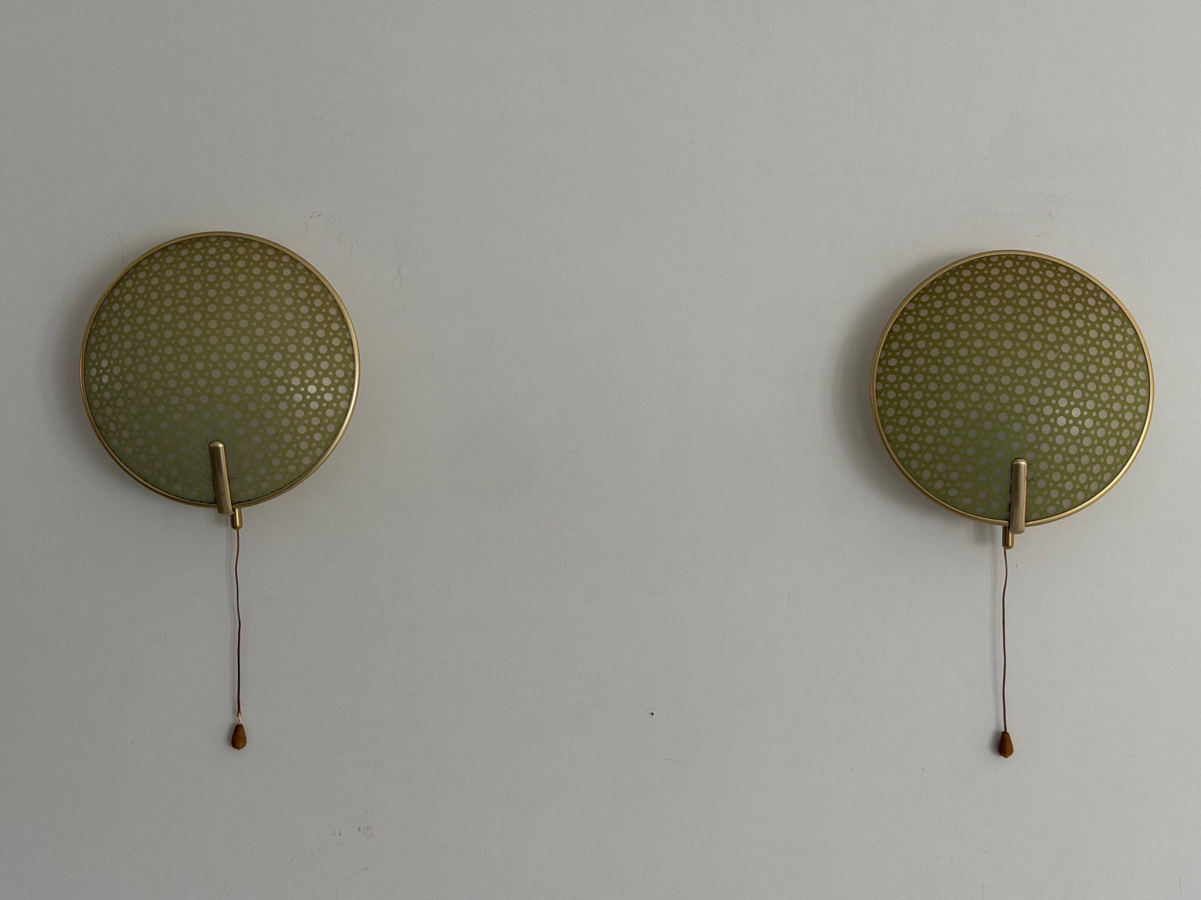 Pair of green plexiglass and gold metal wall lights by Erco, 1950s, Germany.