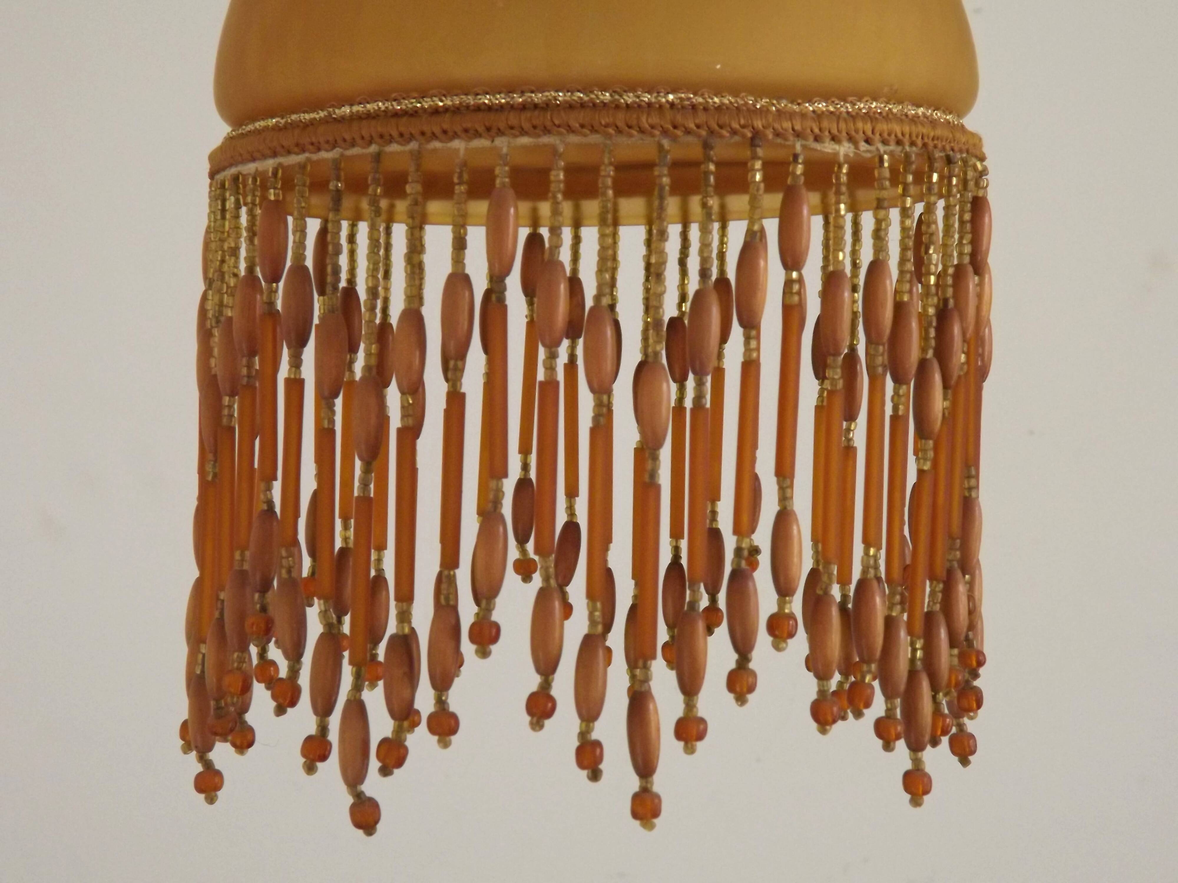 Vintage French amber mottled glass hanging ceiling light with beaded fringe.
