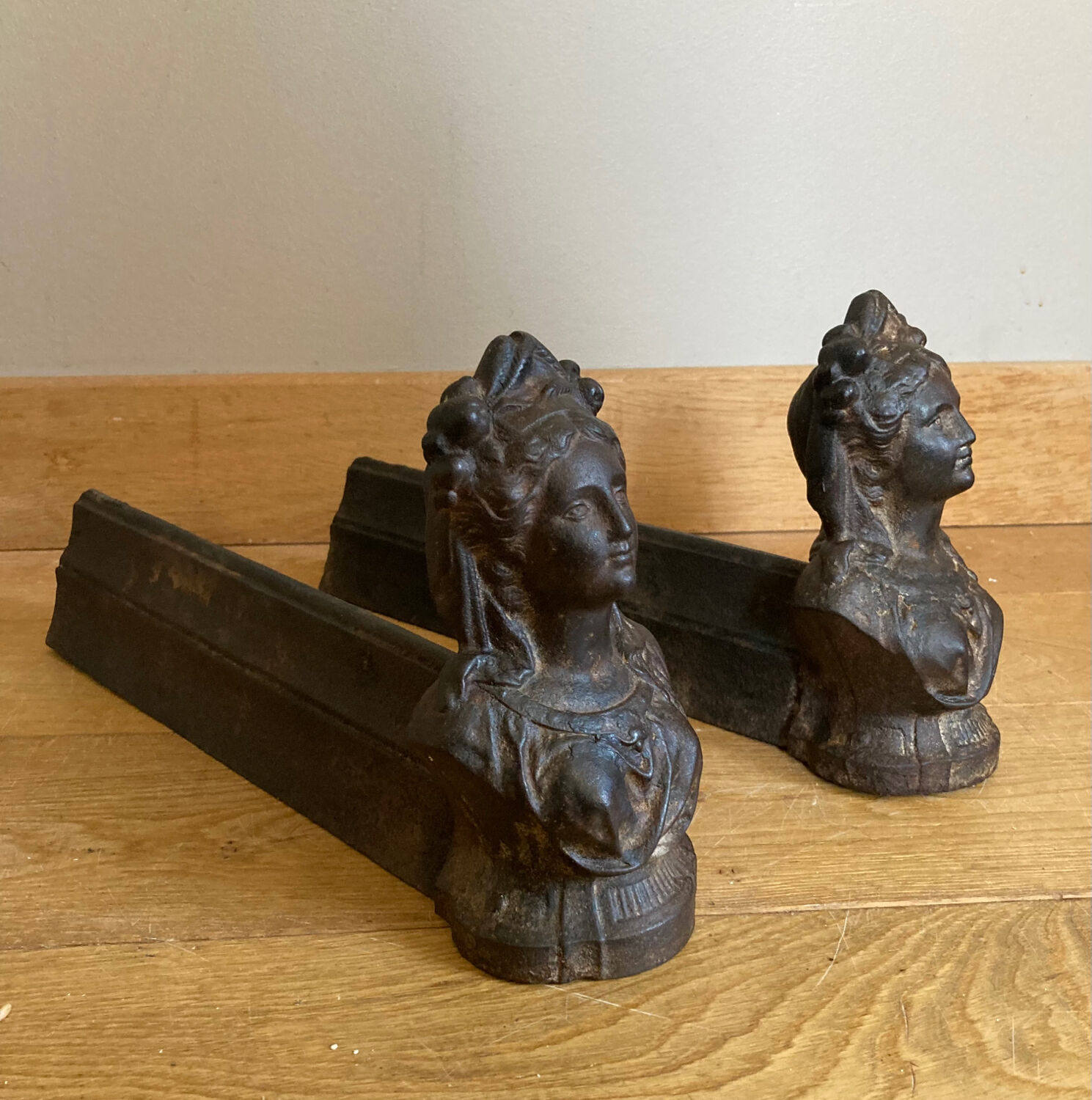 Pair of cast iron andirons from the 19th century, busts of women