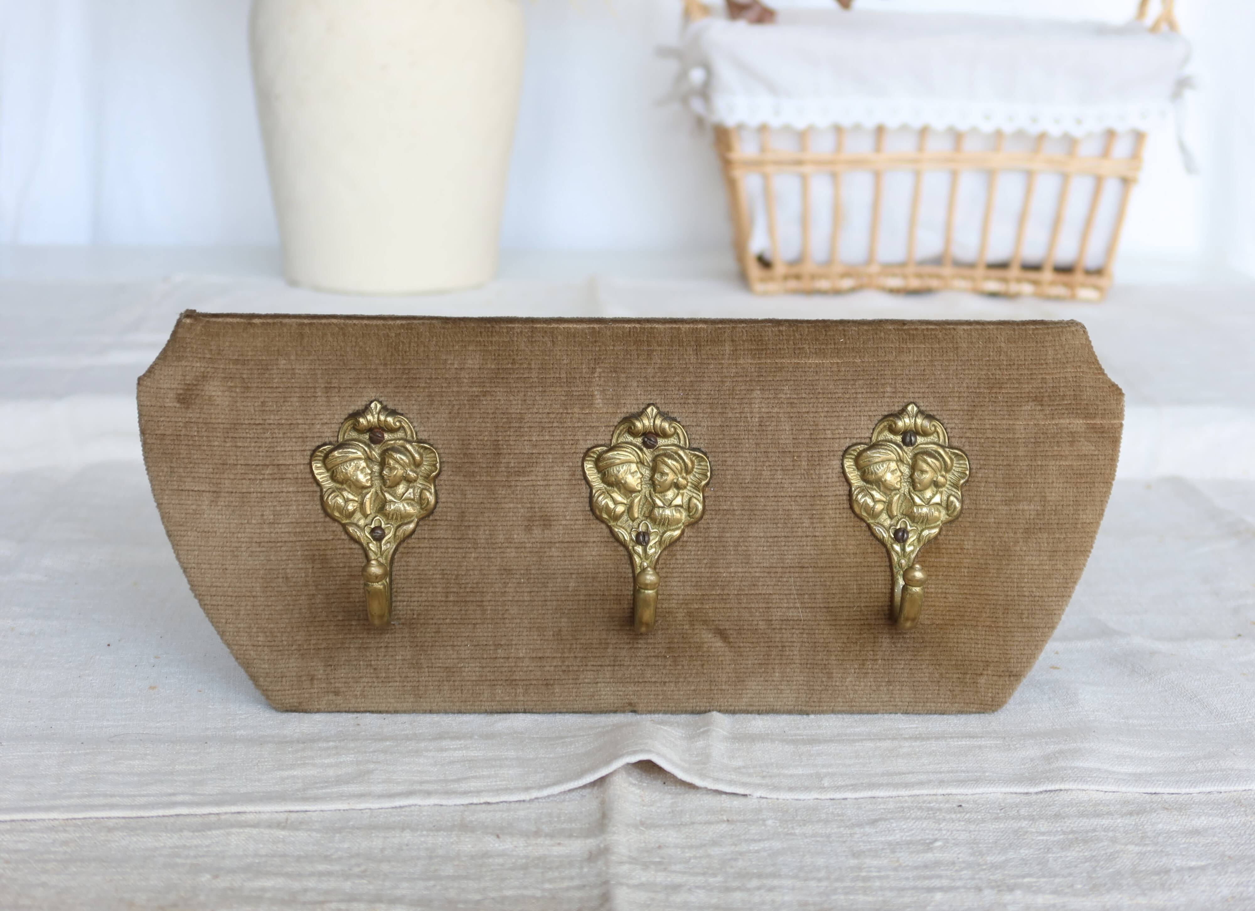 Vintage velvet coat rack with brass hooks