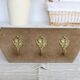 Vintage velvet coat rack with brass hooks