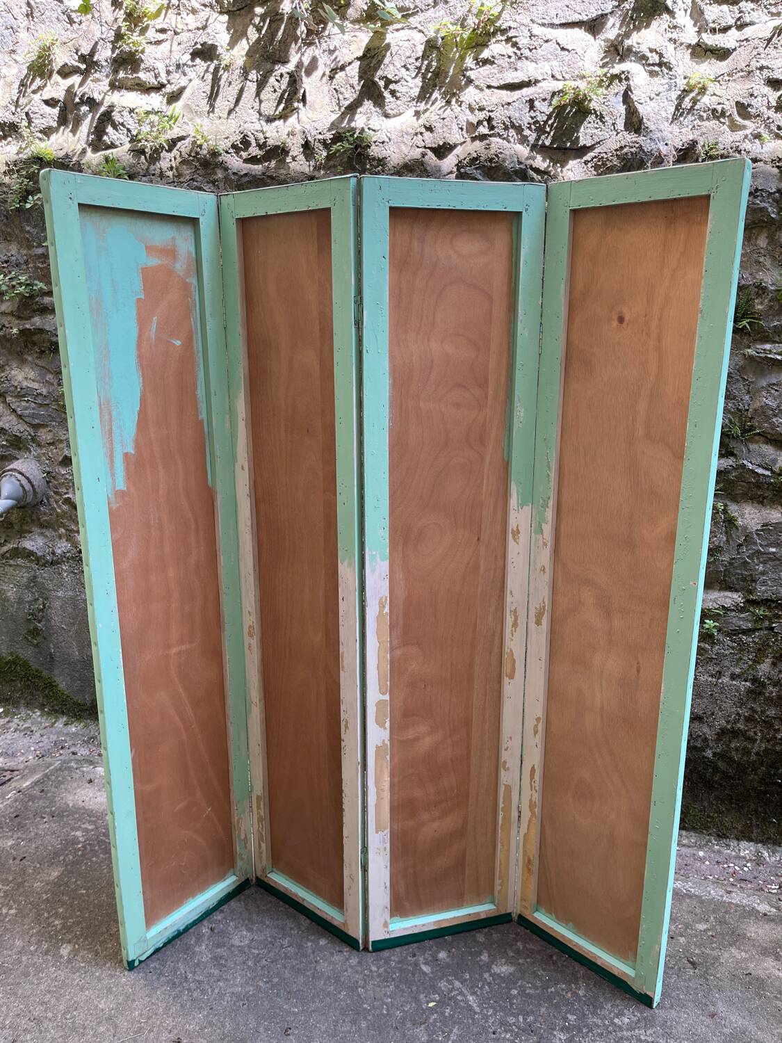 Wooden screen in Asian style, covered with Chinese wallpaper.