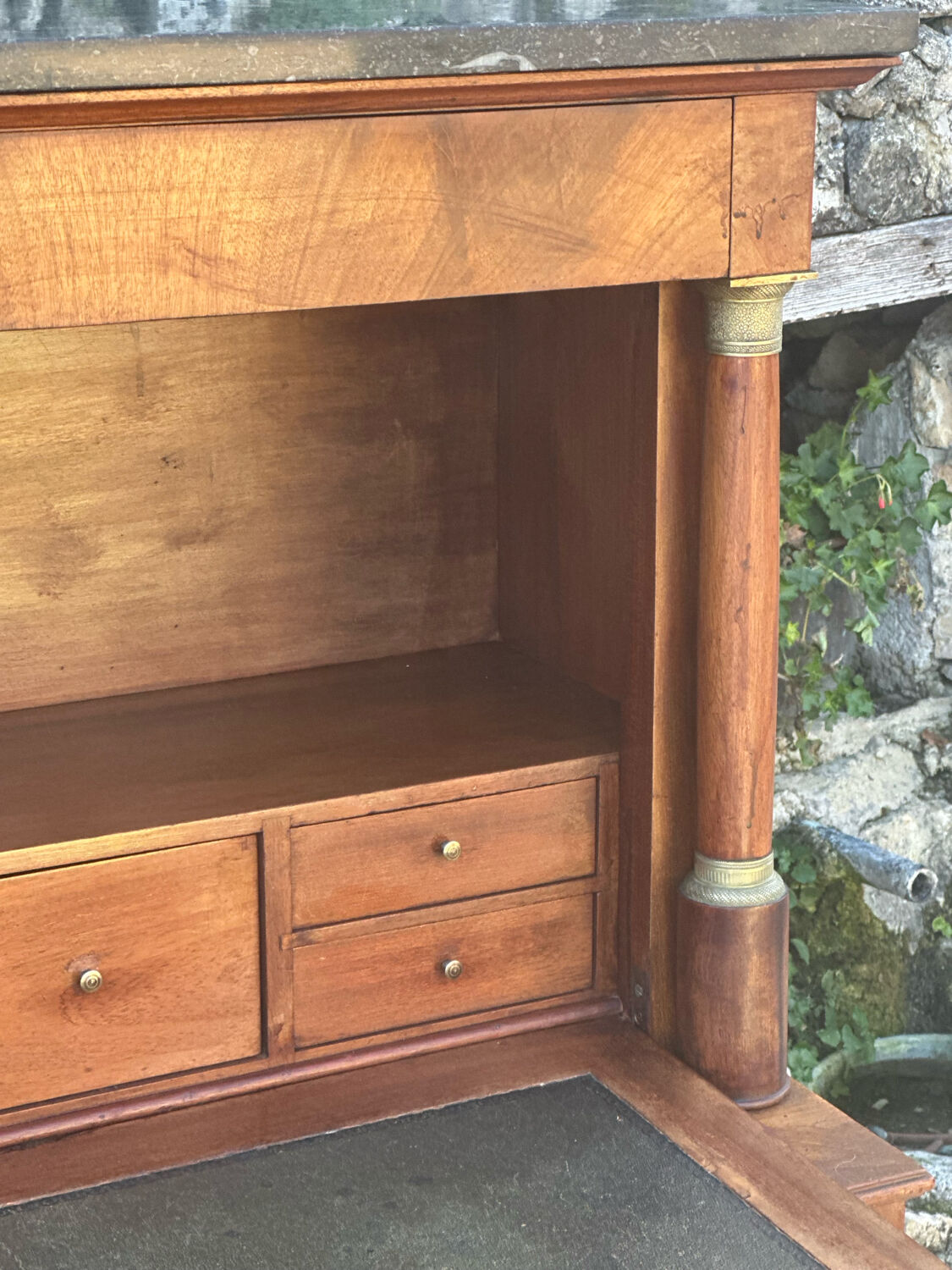 A small piece of Bonheur du jour with detached columns in Empire-era mahogany.