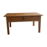 Coffee table with raw wood and a large drawer.