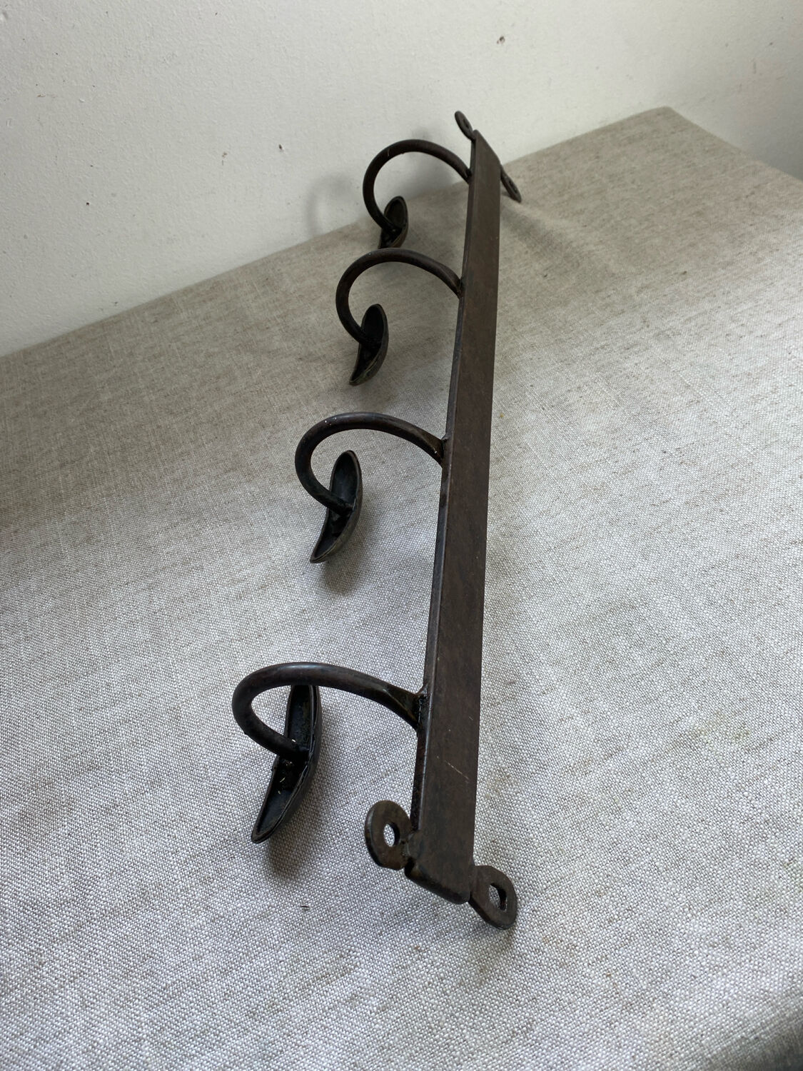Coat rack, four hooks, in wrought iron.