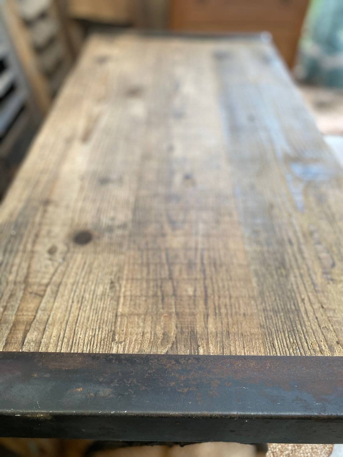 Vintage wooden table with a cast iron base.