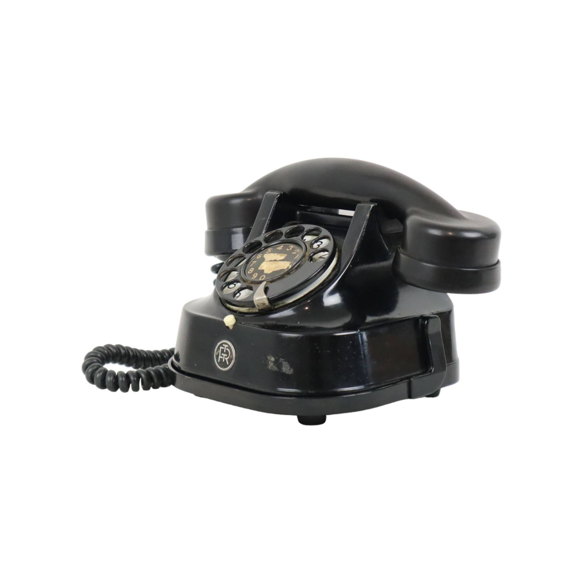 Old black telephone with rotary dial metal Bakelite RTT 56B