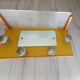 1950s coat rack with mirror, metal hooks, and glass shelf.