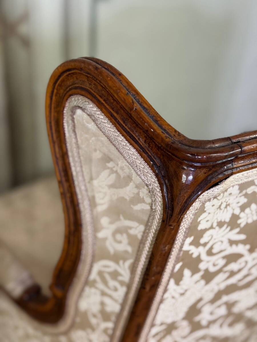 Pair of small Louis XV style wing chairs in carved walnut, Bosson stamp