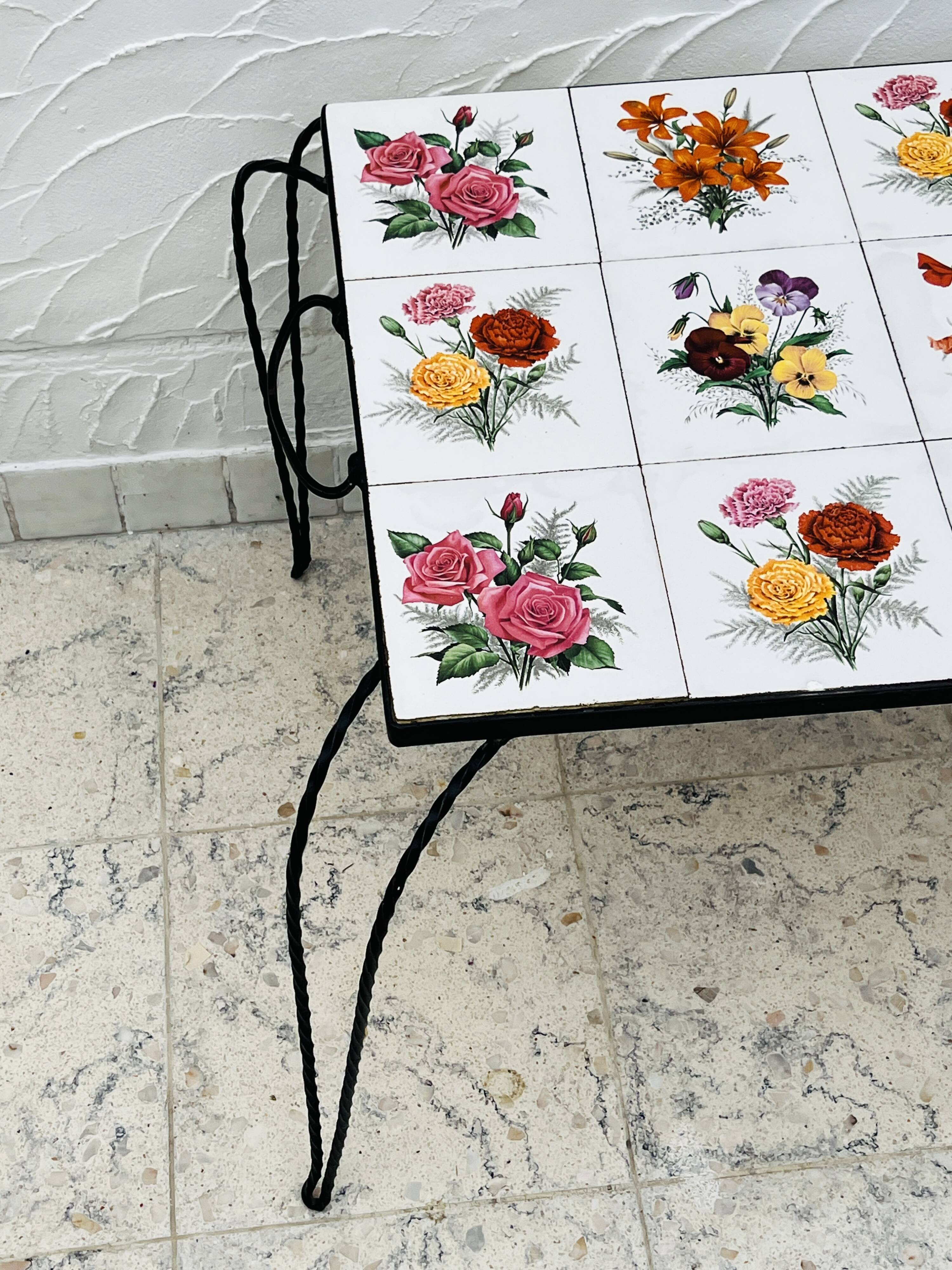 Vintage coffee table in wrought iron with floral tiles.