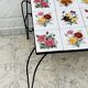 Vintage coffee table in wrought iron with floral tiles.