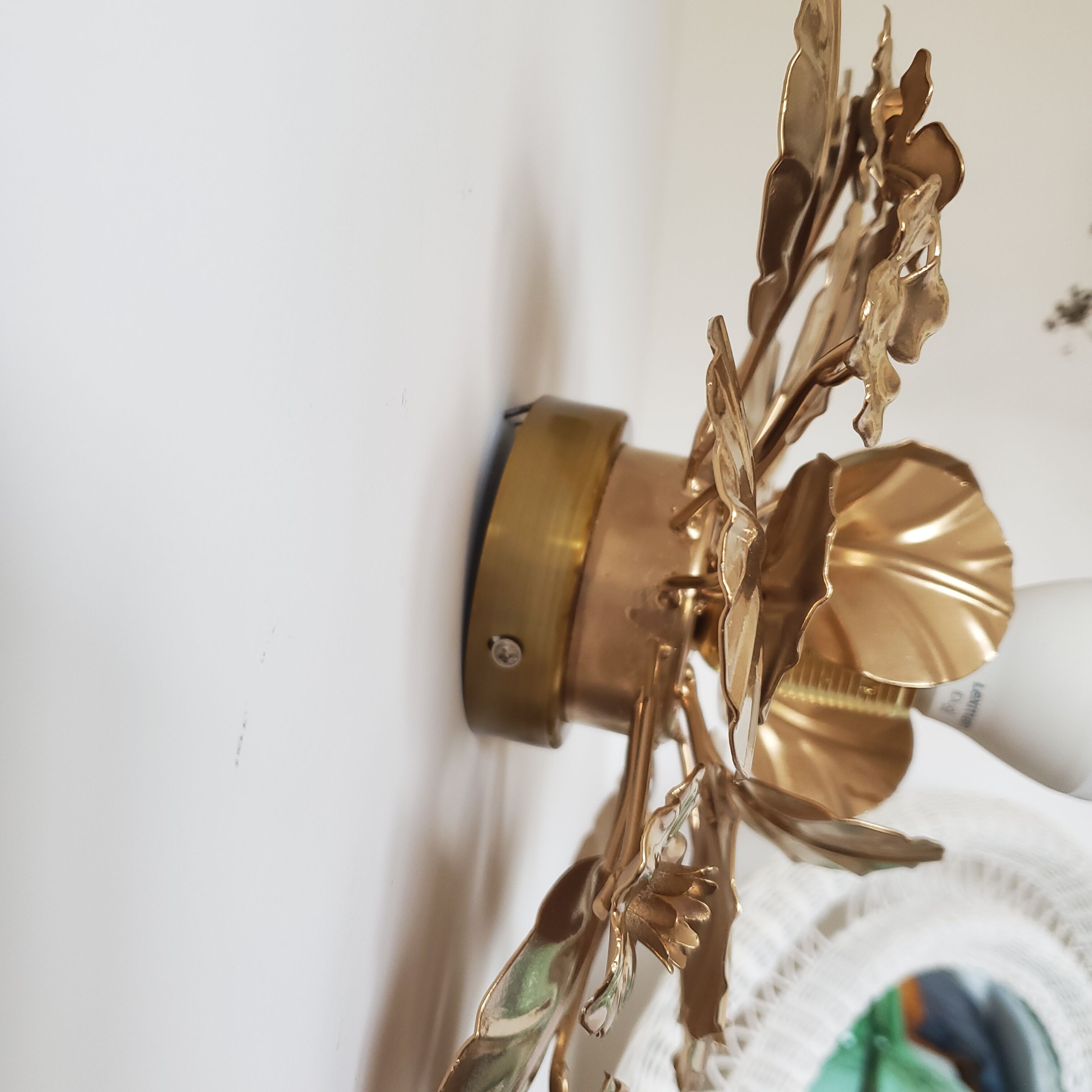 Golden metal flower sconces