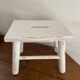Small footrest bench in patinated white wood
