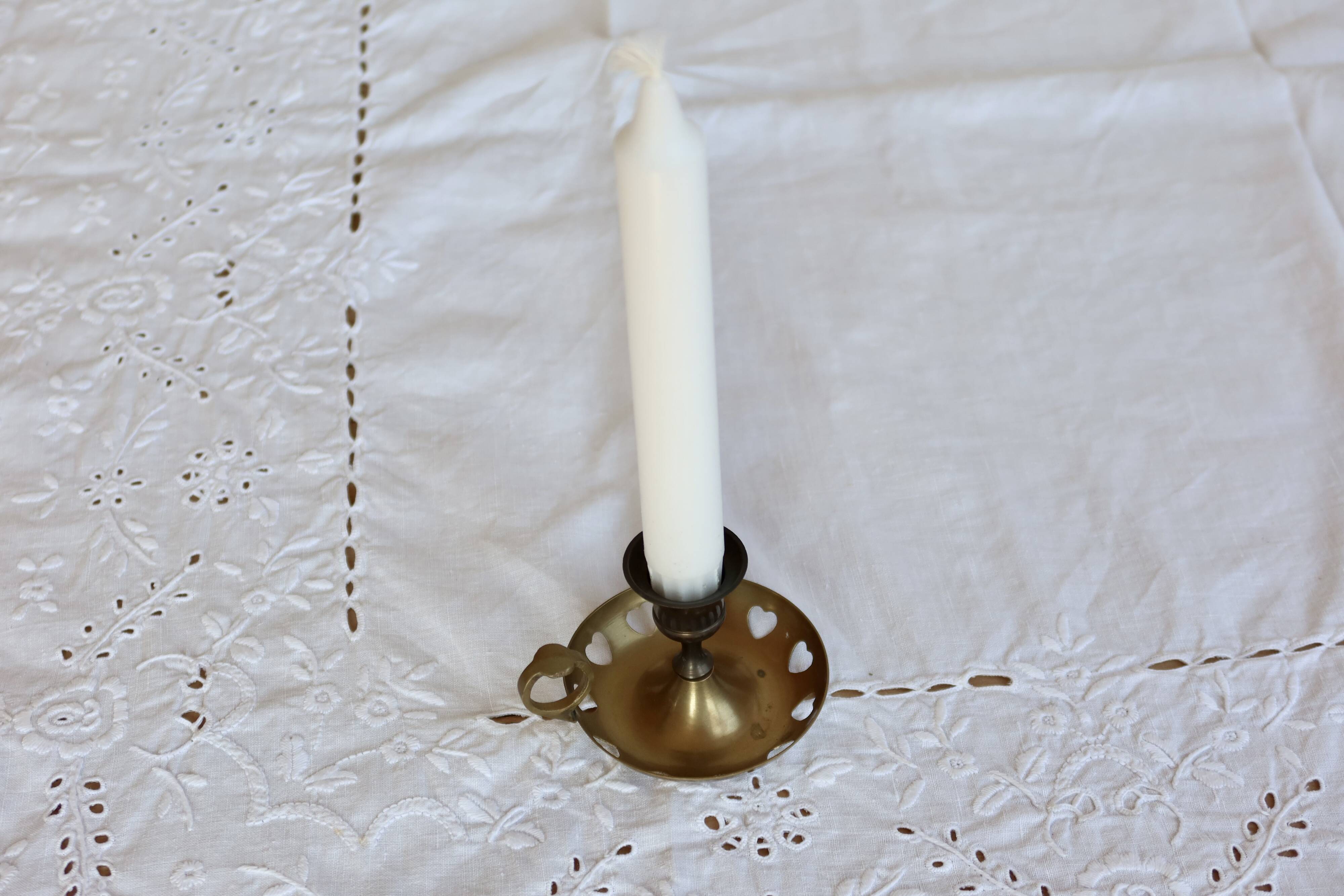 Antique brass rat trap with heart patterns.