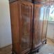 Large English-style wardrobe with a curved front and three doors.