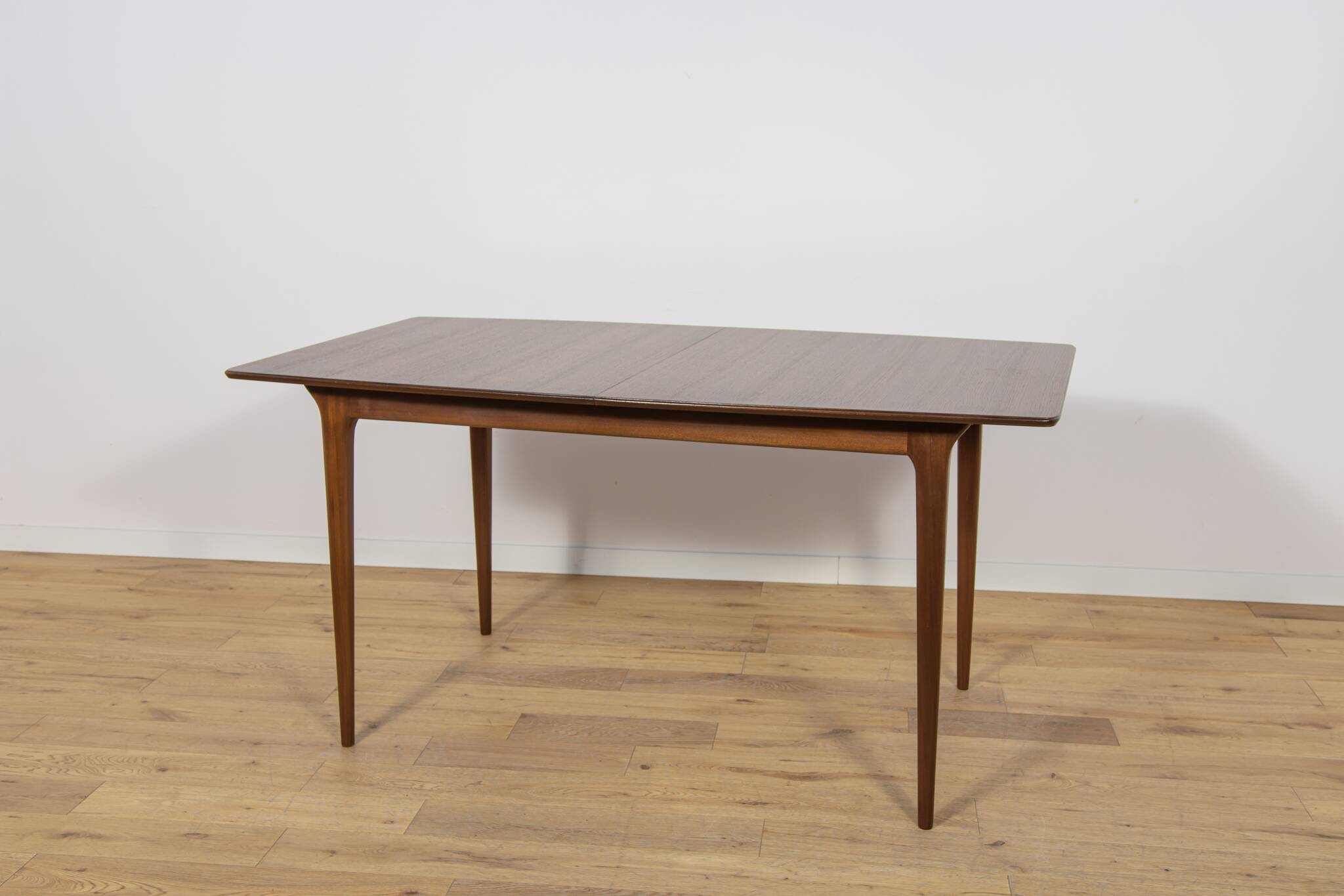 Extendable teak dining table in Mid-Century style from McIntosh, UK.