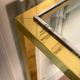 Golden and chrome metal console, bevelled glass, circa 1980.