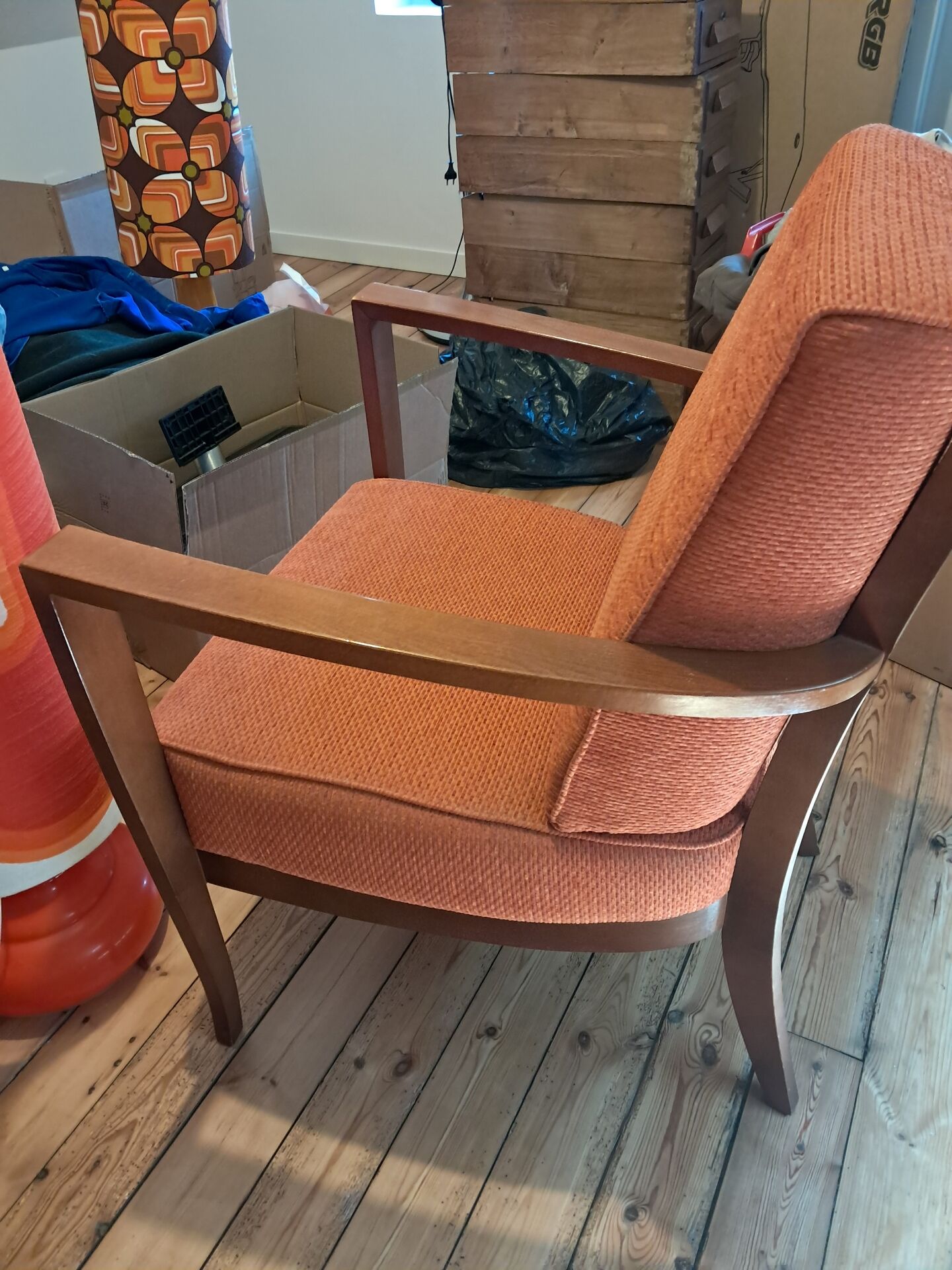 Vintage Art Deco armchair in curved wood and terracotta fabric.