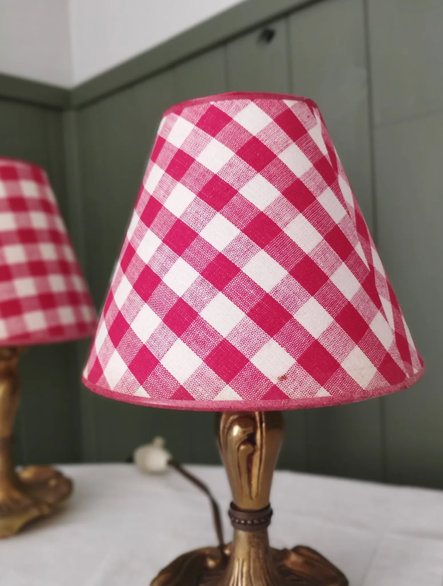 Pair of small lamps in gilded bronze by Petitot and red gingham lampshades.