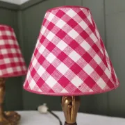 Pair of small lamps in gilded bronze by Petitot and red gingham lampshades.