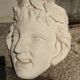 Old face in plaster antique decoration