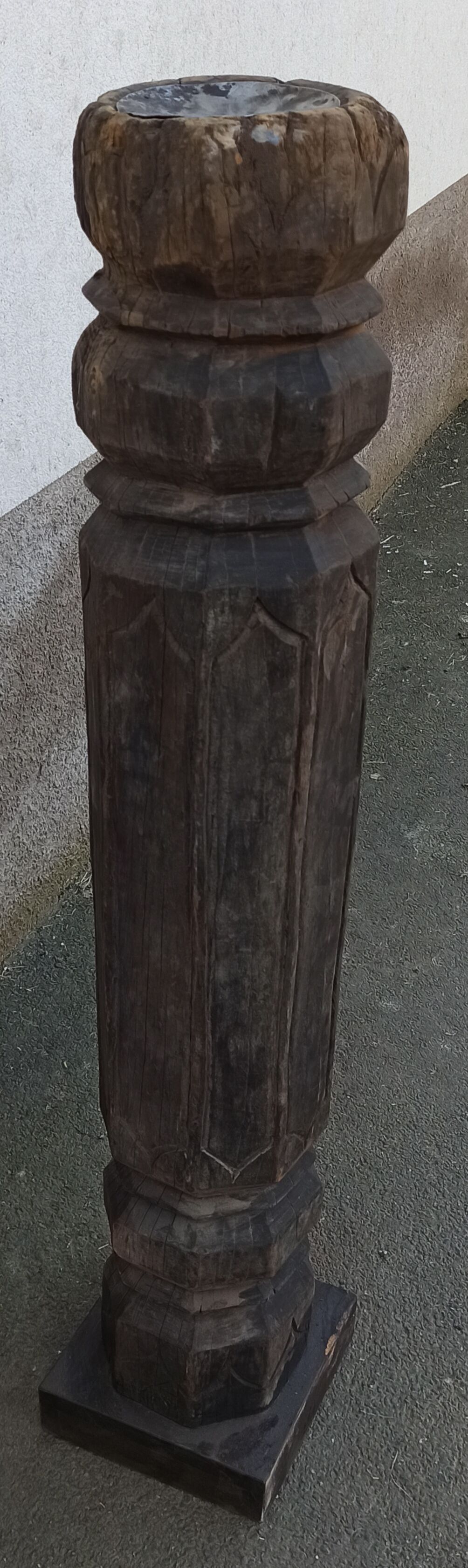 Old wooden pillar on pedestal