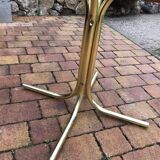 Octagonal table in brass and glass, brown and straw yellow — Hollywood Regency style.