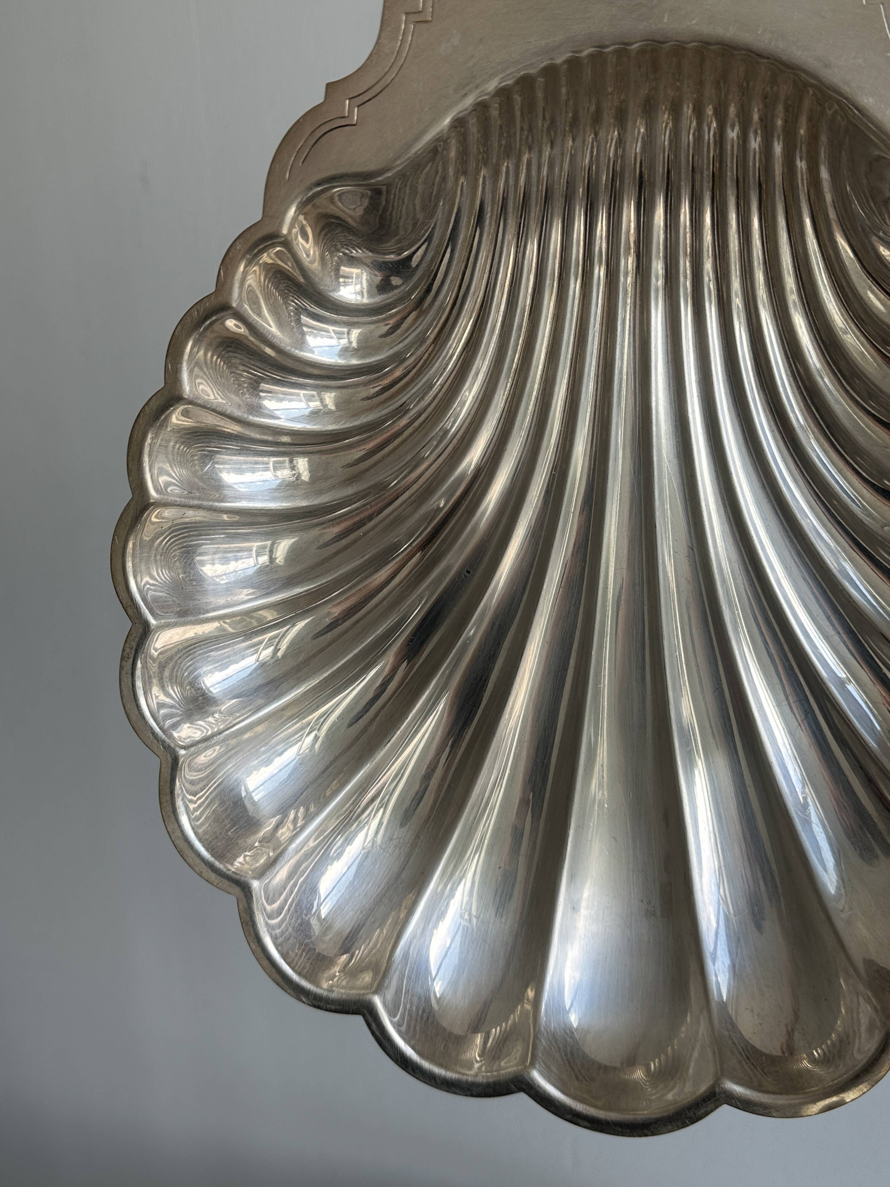 large silver-plated metal shell-shaped dish