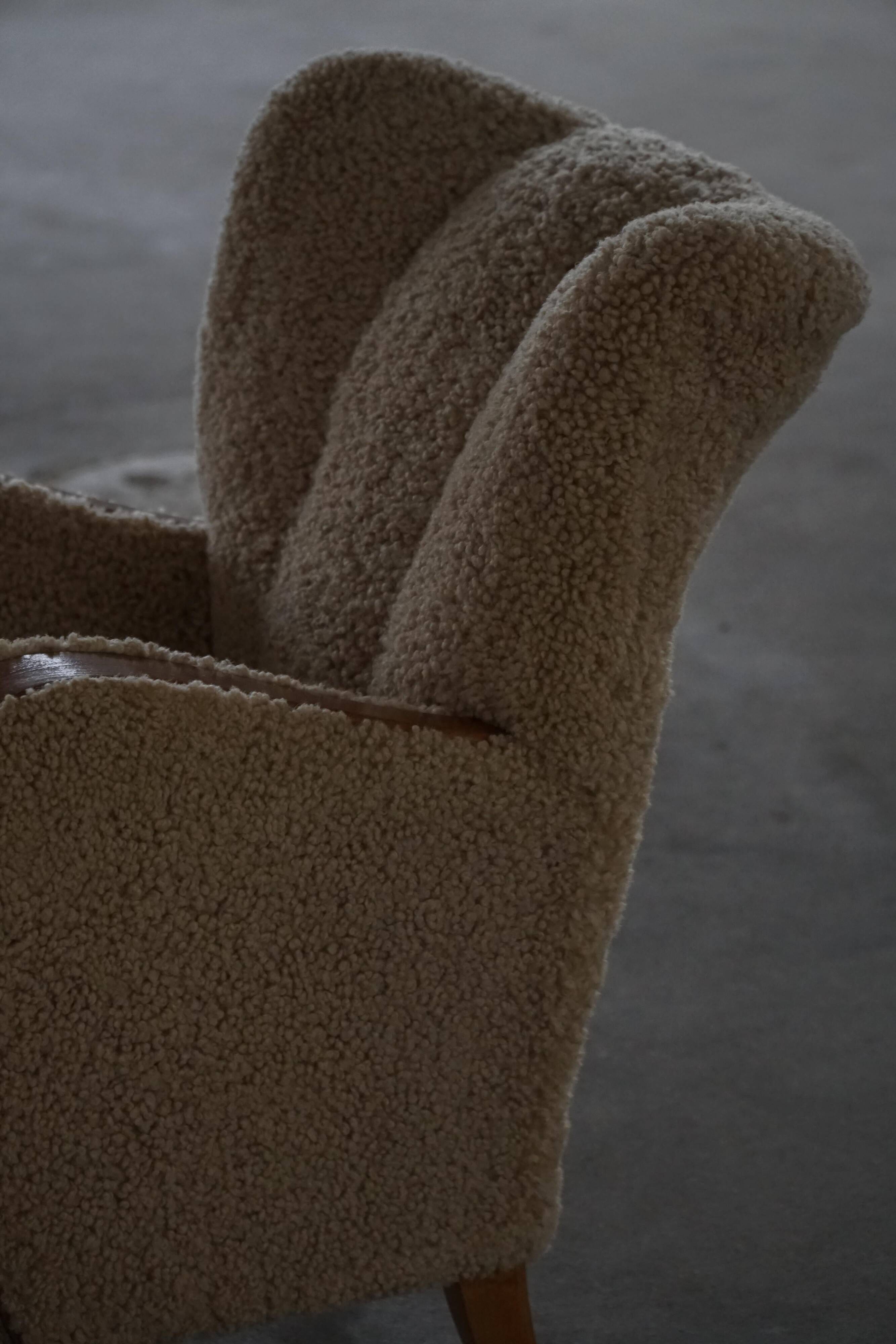 Pair of Danish Art Deco modern lounge chairs in sheepskin with lambswool and elm, 1940s.