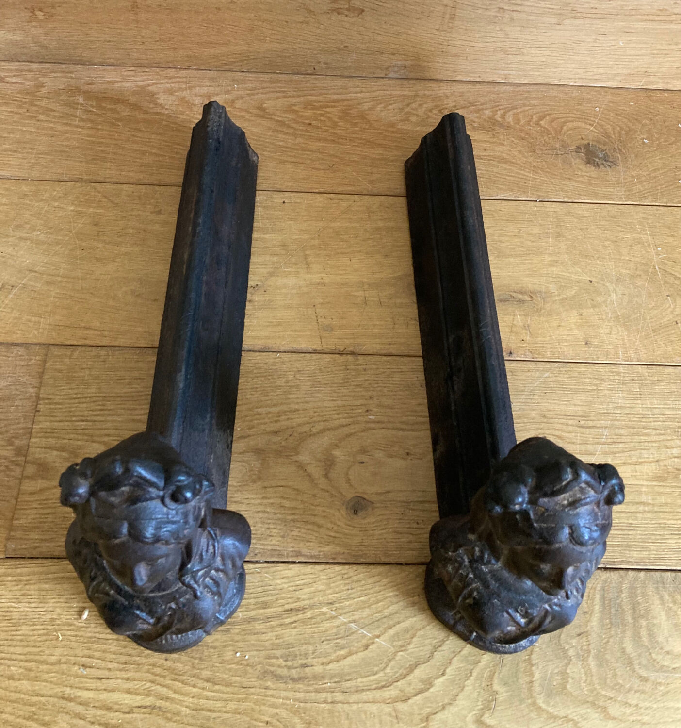 Pair of cast iron andirons from the 19th century, busts of women