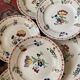 7 hand-painted flowered dinner plates.