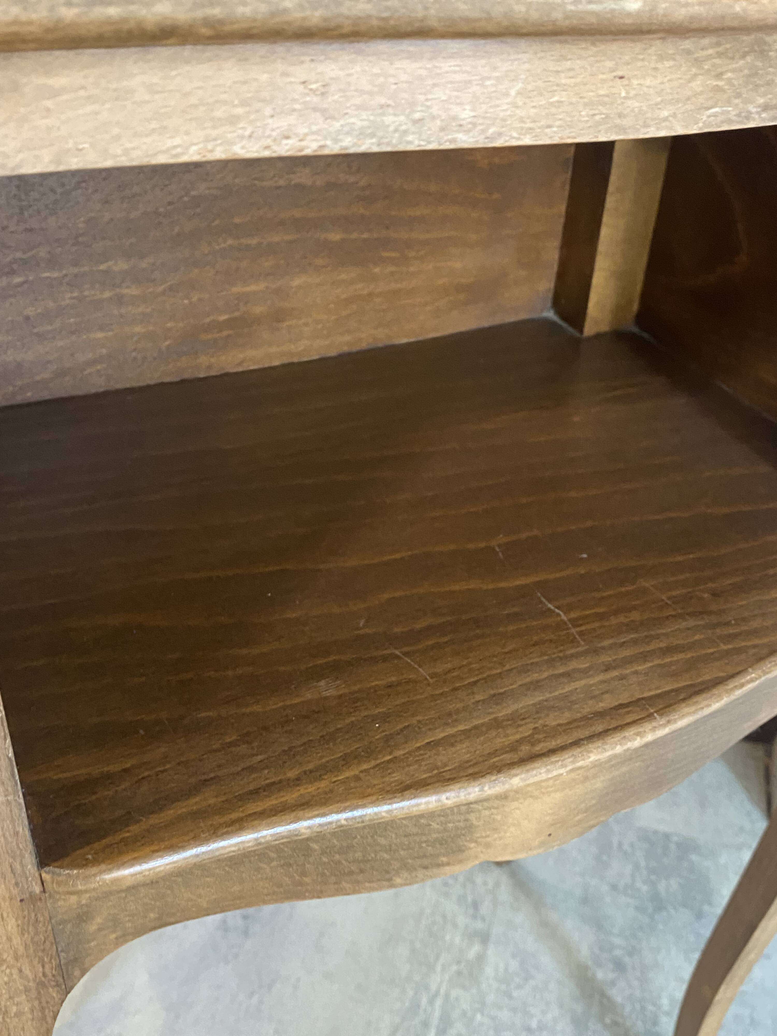 A bedside table with a drawer and a niche in Louis XV style.