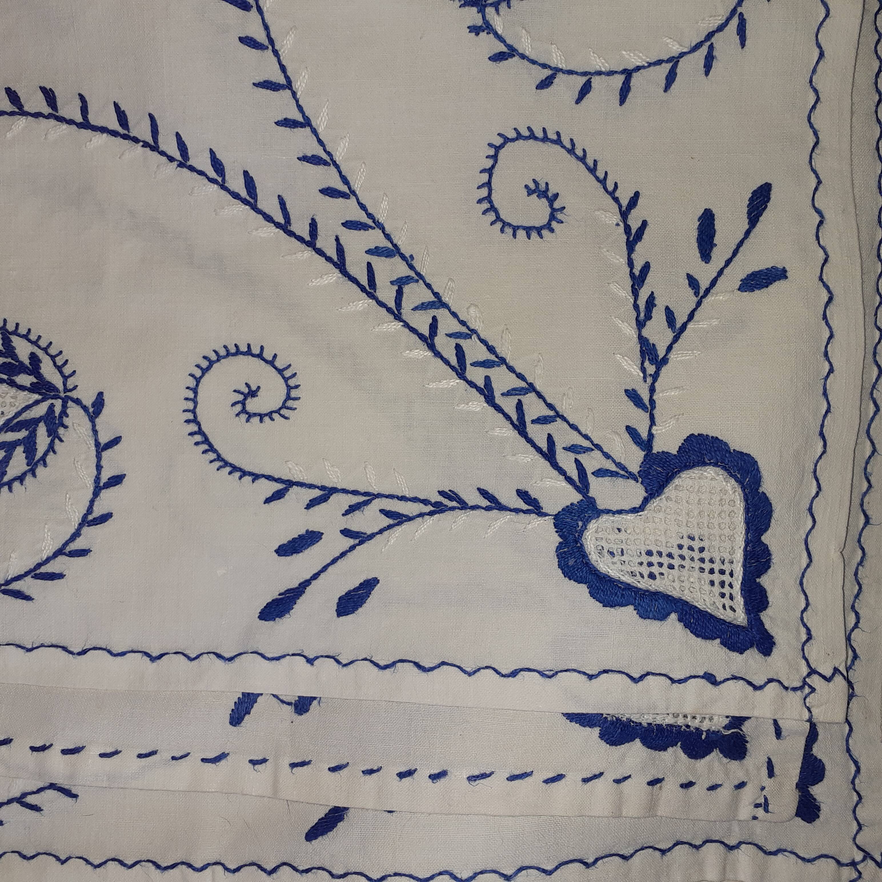Old white background and blue embroidery.