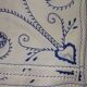 Old white background and blue embroidery.