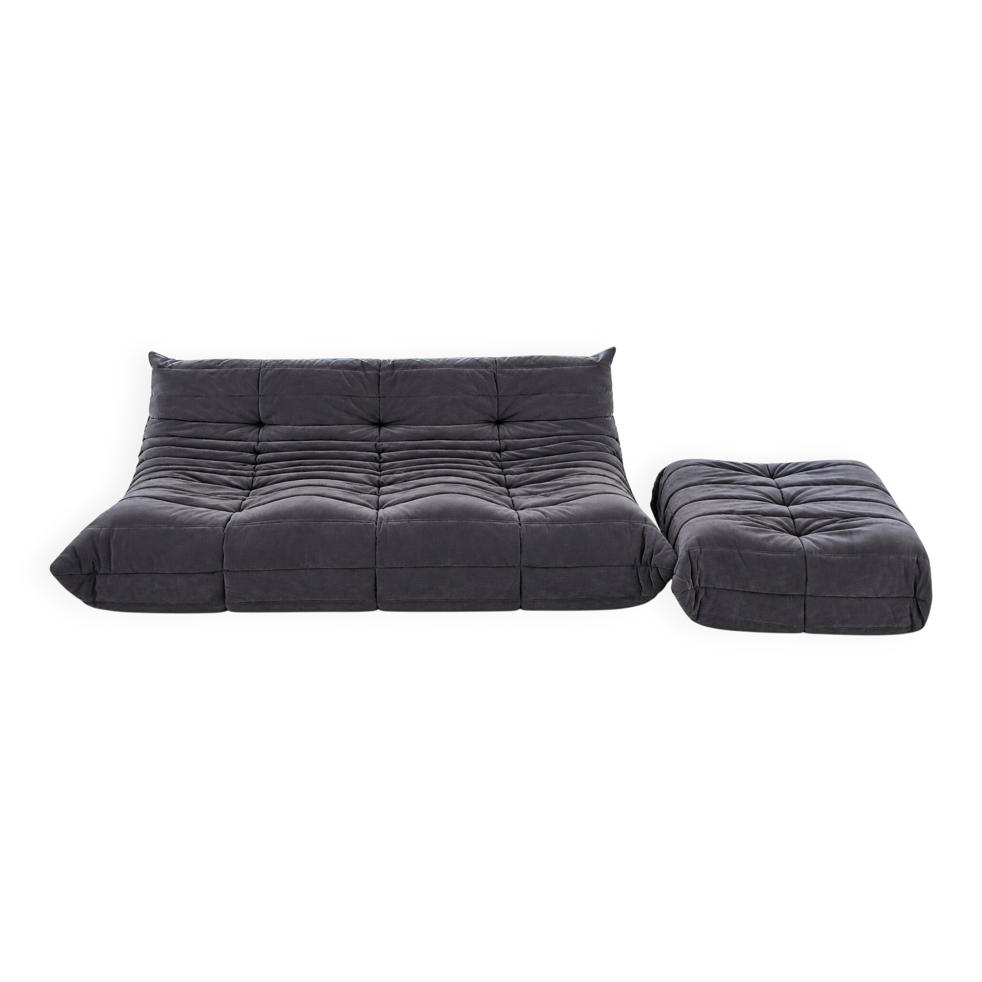 Togo 3-seater sofa by ligne roset with an ottoman.
