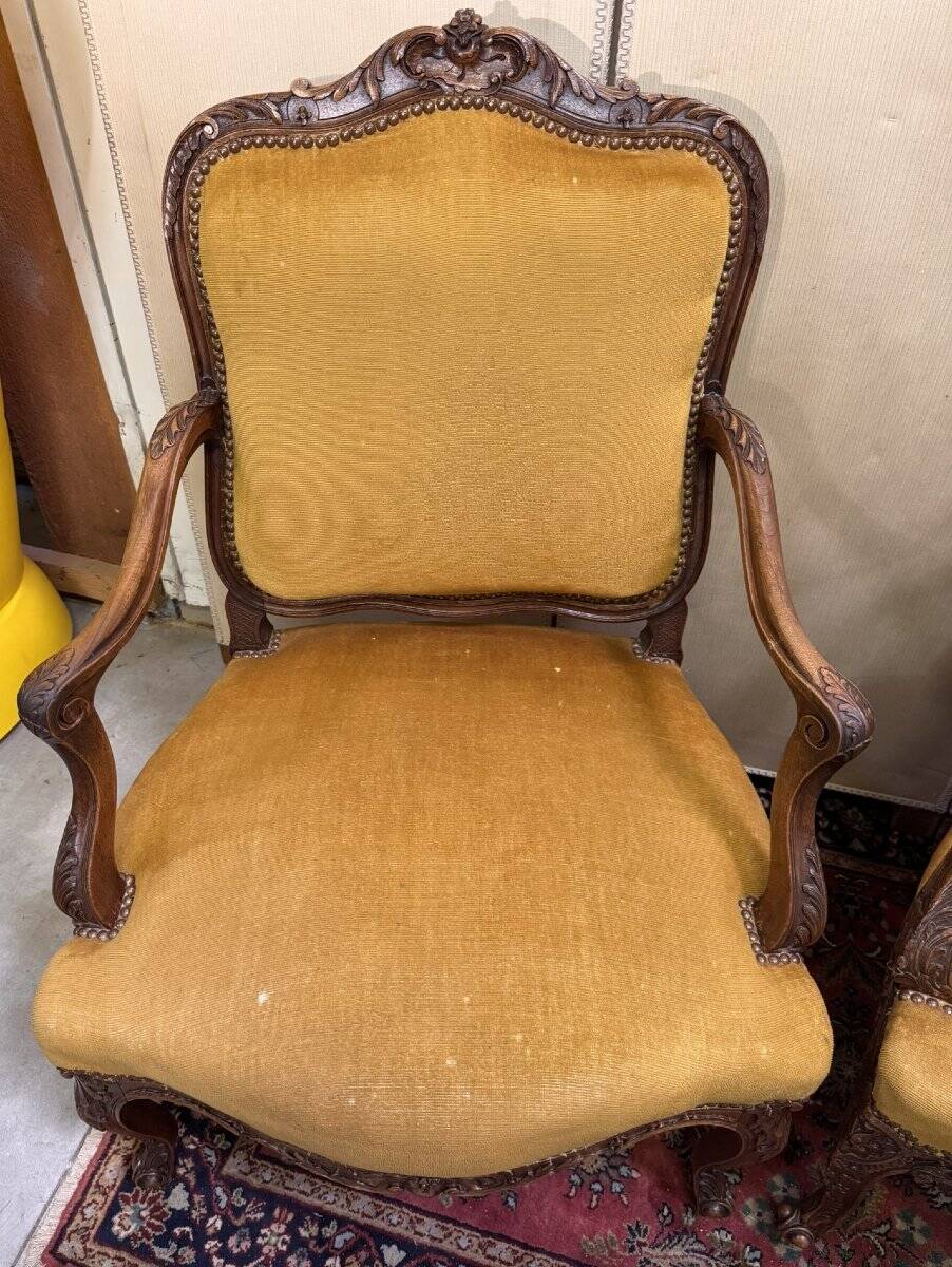 Pair of faux Louis XV armchairs in fully carved walnut